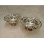 A pair of continental white metal dessert bowls having extensive pierced foliate decoration to