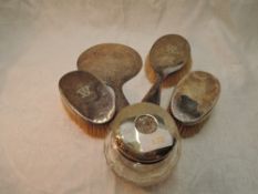 A four piece matched silver dressing table set of plain form bearing letter W to backs, Birmingham