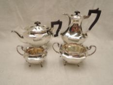 A four piece silver tea set of waisted baluster form having decorative moulded rims, scallop and paw