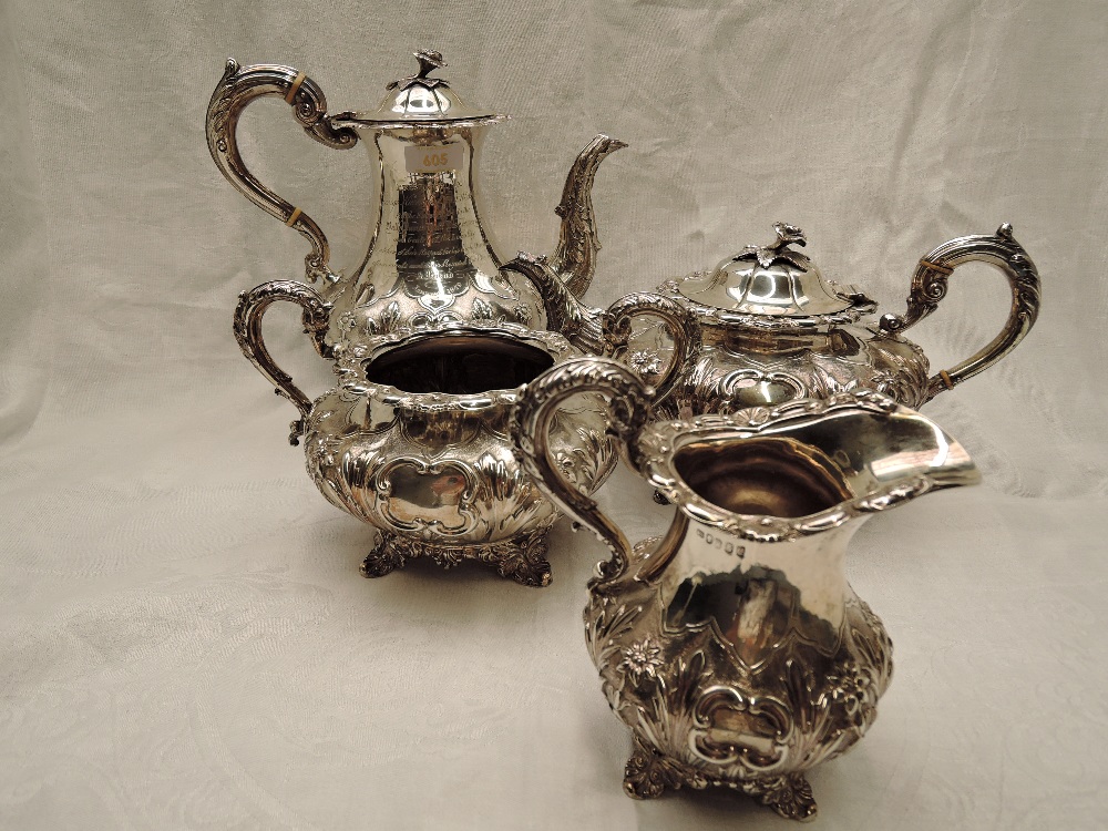 A Victorian Irish silver four piece matched tea set of goad form having extensive repousse and