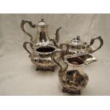 A Victorian Irish silver four piece matched tea set of goad form having extensive repousse and