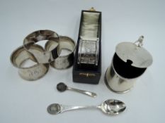 Three HM silver napkin rings (2 & 1) a cased HM silver napkin ring and an HM silver mustard pot of