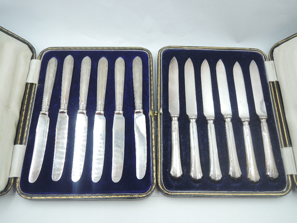 A cased set of six HM silver handled tea knives and a cased set of silver handled dessert knives