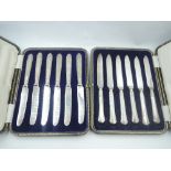 A cased set of six HM silver handled tea knives and a cased set of silver handled dessert knives