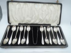 A cased set of twelve silver teaspoons with matching sugar nips having moulded terminals, Birmingham