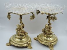 A pair of Victorian gilt plate pedestal bon-bon dishes having cut glass bowls on ornate stands