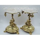 A pair of Victorian gilt plate pedestal bon-bon dishes having cut glass bowls on ornate stands