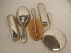 A silver six piece dressing table set of plain form having decorative edges and bearing monogram