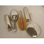 A silver six piece dressing table set of plain form having decorative edges and bearing monogram