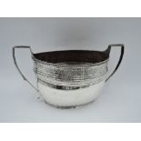 A large Georgian silver sugar bowl of oval form having engraved decoration, gadrooned rim and