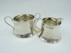 A silver cream jug and sugar bowl of small plain tapered circular form, Sheffield 1921, Walker &