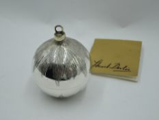 A Stuart Devlin 1983 silver Christmas tree bauble having etched decoration and lift off cover