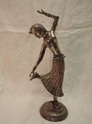 A white metal study of a Far Eastern dancing figurine having moulded and engraved decoration on a
