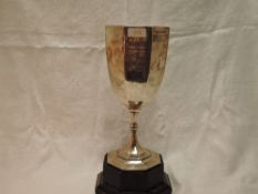 An Edwardian silver oversized trophy cup of octagonal goblet form bearing presentation