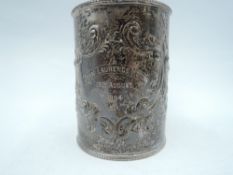 A Victorian silver Christening mug having scroll repousse decoration and presentation inscription to