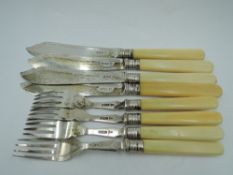 An Edwardian four place setting of fish knives and forks having bone handles and silver blades,