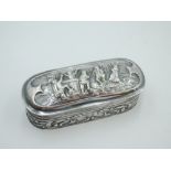 A small Dutch silver trinket box having hinged lid and extensive scenic repousse decoration,