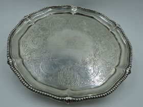 A Victorian silver salver having gadrooned pie crust rim, engraved decoration with central crest and