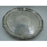 A Victorian silver salver having gadrooned pie crust rim, engraved decoration with central crest and