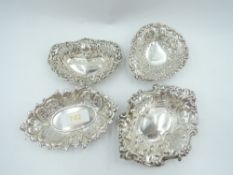 Four HM silver trinket dishes of different shapes, all having pierced and repousse decoration,
