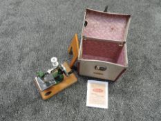 A child's Grain sewing machine in original carrying case with photocopied instructions