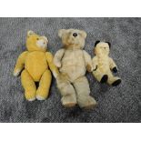 Three mid 20th century straw filled yellow plush Teddy Bears, plastic eyes and nose, stitched