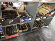 A large collection on four shelves containing nine boxes of 0 gauge including Hornby and similar,