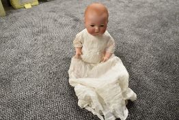 An early 20th century Armand Marseille bisque headed doll having sleep eyes, closed mouth and