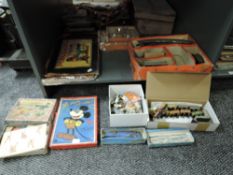 A shelf of vintage toys and games including a Britains diecast Bluebird model, Japanese tin plate