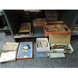 A shelf of vintage toys and games including a Britains diecast Bluebird model, Japanese tin plate