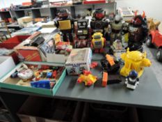 A collection of mixed vintage battery operated and similar plastic Robots and similar accessories