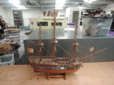 A modern hand made wooden model of a Frigate with St Georges Flags, on wooden stand, overall
