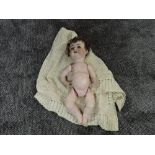 An early 20th century Alt Beck & Gottschalck bisque headed doll having sleep blue eyes, open mouth