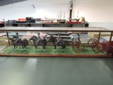 A modern model of six horses pulling Cannon Lumber with five Napoleonic soldiers, in wood and