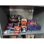 A shelf of 1980's and later diecasts including Corgi in blue and red boxes, Days Gone, Exchange