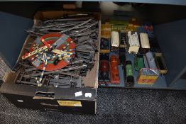 A shelf of Hornby and similar clockwork 0 gauge 0-4-0 loco's and tenders, tin plate rolling stock