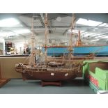 A modern hand made wooden model of a Frigate, on wooden stand, overall height 75cm, length 90cm