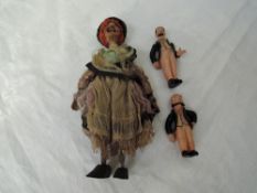 A vintage wooden hand made Witch Doll, length 23cm along with two HCF Germany celluloid miniature