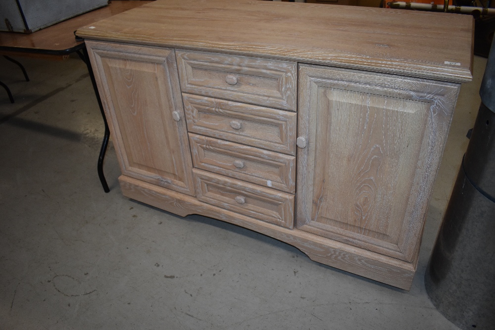 A modern laminate lime oak effect sideboard, on castors, width approx. 128cm