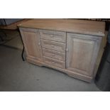 A modern laminate lime oak effect sideboard, on castors, width approx. 128cm