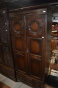 An early 20th Century oak single wardrobe having dummy base, width approx. 94cm