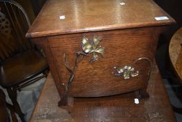 An Arts and Crafts oak lidded box, possibly coal or kindling, unlined, having foliate applique