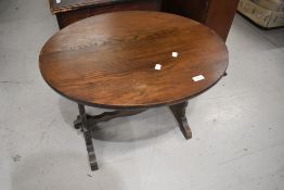 A vintage oak oval occasional table, width approx. 66cm