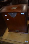 An early 20th Century mahogany smokers cabinet, includes fittings and tobacco jar, with plaque for