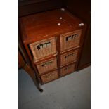 A stained frame and wicker storage unit