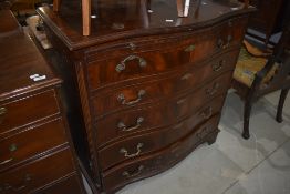 A reproduction Regency serpentine fronted chest of five drawers (plus brushing slide) width