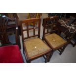 A pair of early to mid 20th Century oak dining chairs
