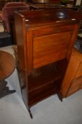 A Victorian mahogany writing bureau of shallow form with two bookshelves under, includes key,