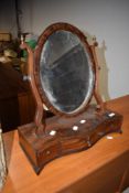 An early 20th Century mahogany toilet mirror having shaped drawer base