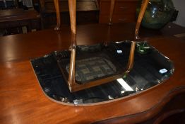 A vintage frameless wall mirror having shaped edge, width approx. 68cm